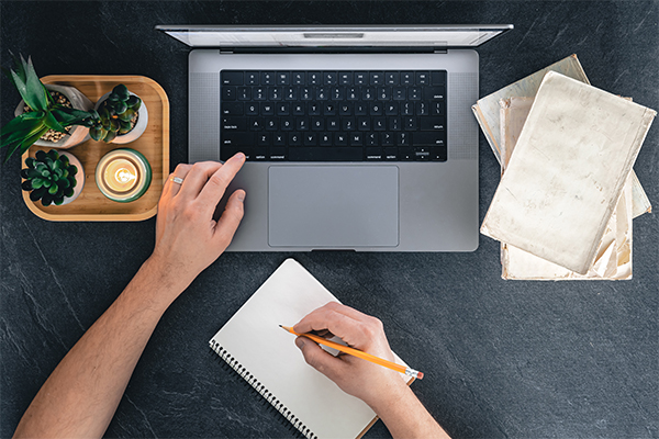 A person working on graphic design software with various design elements on the screen